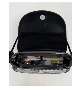 Interior view of checkered crossbody bag with magnetic closure and zippered inner pocket