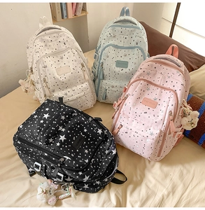 Detail view of large capacity school backpacks in four colors with star print and cute charms
