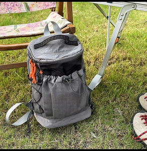 Close-up of durable nylon hiking backpack with mesh pocket in a scenic camping setting