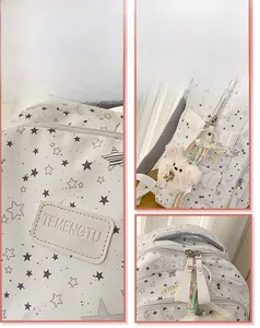 Detail display of star print backpack with plush bear charm and sturdy zippers