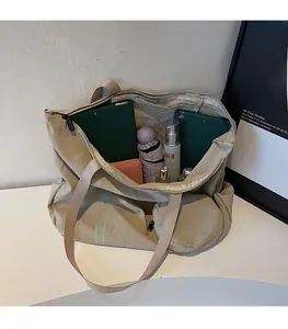 Spacious interior of large canvas tote bag showing storage for tablet and umbrella