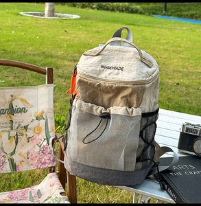 Detail of outdoor backpack featuring mesh pocket, drawstring, and contrast stitching detail