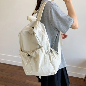 Minimalist cream nylon backpack for women with front drawstring pocket and side pockets
