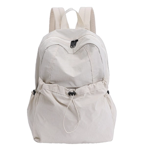 Minimalist beige nylon backpack with large drawstring front pocket for travel and commute