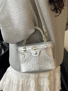 Silver metallic box bag with vintage denim pocket design and elegant top handle strap