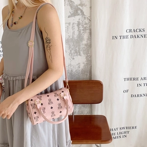 Detail of pink cylinder boston bag with cartoon bear print and adjustable strap
