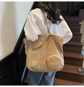 Gros plan du sac cabas kaki avec motif chat et son petit porte-monnaie assorti