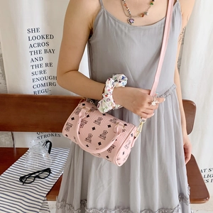 Pink cartoon bear cylinder bag on a model showing daily use size and faux leather texture