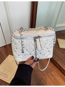 White quilted chain bag with crystal studs and camellia pendant for modern women