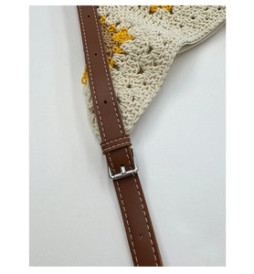 Detail of adjustable leather strap and floral knit texture of the large tote bag