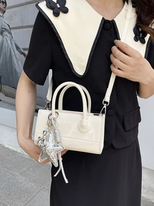 Fashionable cream patent leather crossbody bag with silver star charm and round handles