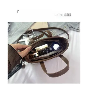 Detail view of the spacious inner compartment of the woven bag with daily essentials