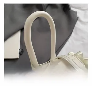 Close-up of comfortable leather handle on a cream lace backpack with ruffle details