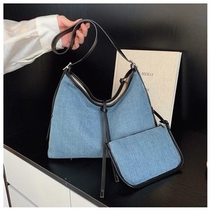 Detailed set of denim tote bag and matching small pouch with leather trim and shoulder strap