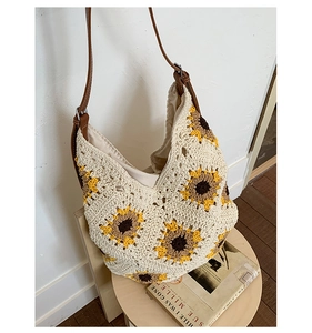 Detail of sunflower crochet tote bag featuring hand-woven texture and adjustable strap