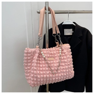 Detail of pink bubble texture tote bag with silver chain, pearls and flower charms