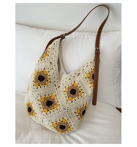 Detail of sunflower crochet bag with cream knit texture and brown faux leather strap