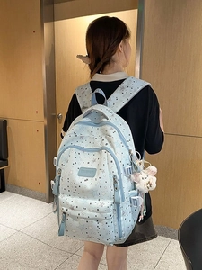 Light blue student backpack with star pattern and cute plush pendant for school girls
