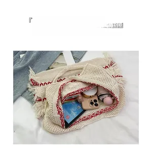 Knitted tote bag internal capacity showing tablet, phone, and fringe detail