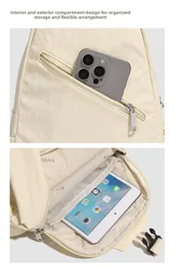 Macro view of multi-compartment storage inside the creamy white nylon crossbody backpack