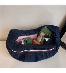 Deep blue denim hobo bag interior displaying spacious capacity for daily essentials