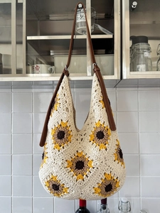 Summer knitted shoulder bag with sunflower crochet pattern and brown leather strap