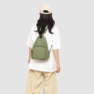 Olive green versatile mini backpack shown on model highlighting daily commute style
