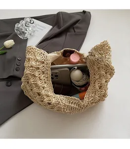 Macro view of straw tote interior showing spacious storage and leather magnetic closure