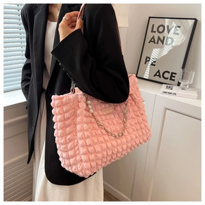 Pink bubble textured tote bag detail with pearl chain and silver metallic hardware accents