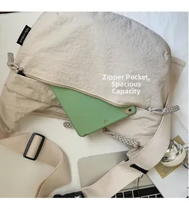 Detail view of front zipper pocket on beige canvas bag holding a green tablet