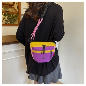 Dettaglio della borsa a tracolla in tela color-block con accenti viola e giallo moda