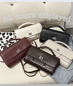 Multiple stylish leather crossbody handbags in five colors displayed on a sofa