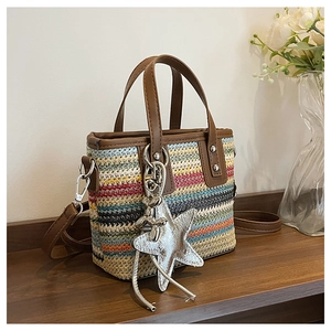 Detail of colorful striped woven tote with star charm on a rustic wooden shelf