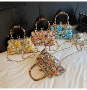 Detail of vintage tote bags with bamboo handles, pearl chains, and daisy floral patterns