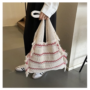 Detailed knit tote bag with red wavy stripes and bohemian tassel fringe decoration
