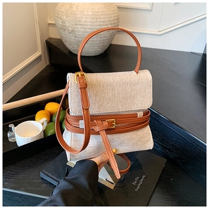 Vue de dessus d'un sac en toile de lin gris clair avec des lanières en cuir marron