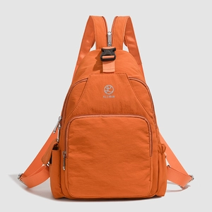 Detailed front view of vibrant orange multi-functional nylon backpack with KLEIMAN logo
