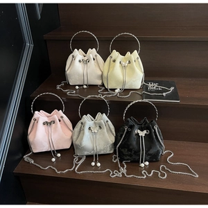 Detailed collection of velvet drawstring bucket bags in five colors with pearl accents