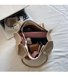 Detailed interior of apricot tote bag showing capacity for 14-inch laptop and essentials