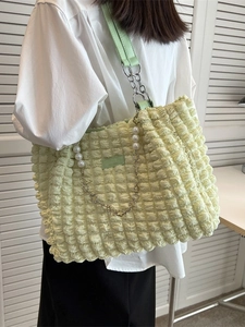Pale green popcorn fabric tote bag with pearl chain detail and elegant shoulder strap