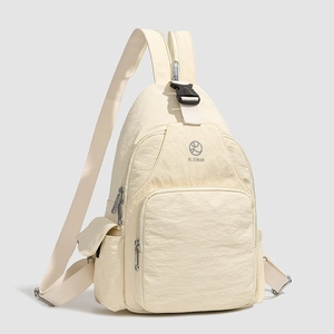 Close-up of cream nylon backpack featuring water-resistant fabric and KLEIMAN logo detail