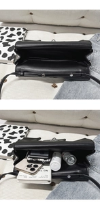 Internal view of the black leather bag showing double compartments and large storage capacity