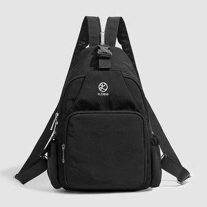 Detail view of the black multi-functional chest bag with multiple zipper compartments