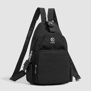 Close-up of black multi-pocket nylon backpack showing KLEIMAN logo and buckle detail