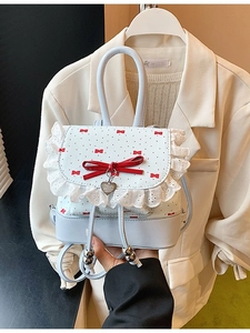 Mini ballet-style backpack with white lace edges, red polka dots, and a heart pendant