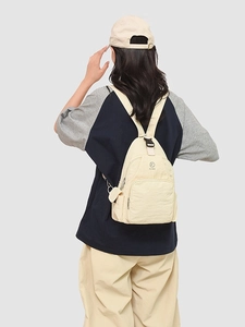 Versatile cream nylon mini backpack with adjustable buckles and multiple zip pockets