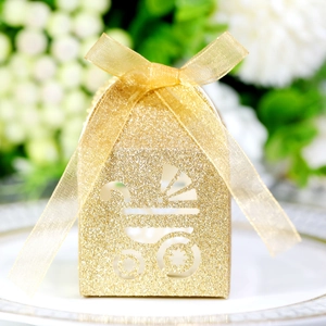 Detail of glitter gold hollow baby stroller candy box with elegant organza ribbon bow