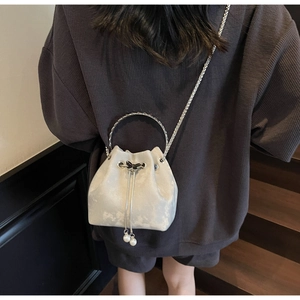 Silver velvet bucket bag featuring pearl charms and a delicate metal ring handle