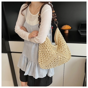 Detail of hand-woven beige tote bag with natural wooden bead shoulder straps
