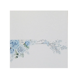 Macro shot of elegant floral wedding place card with blue roses and butterfly detail